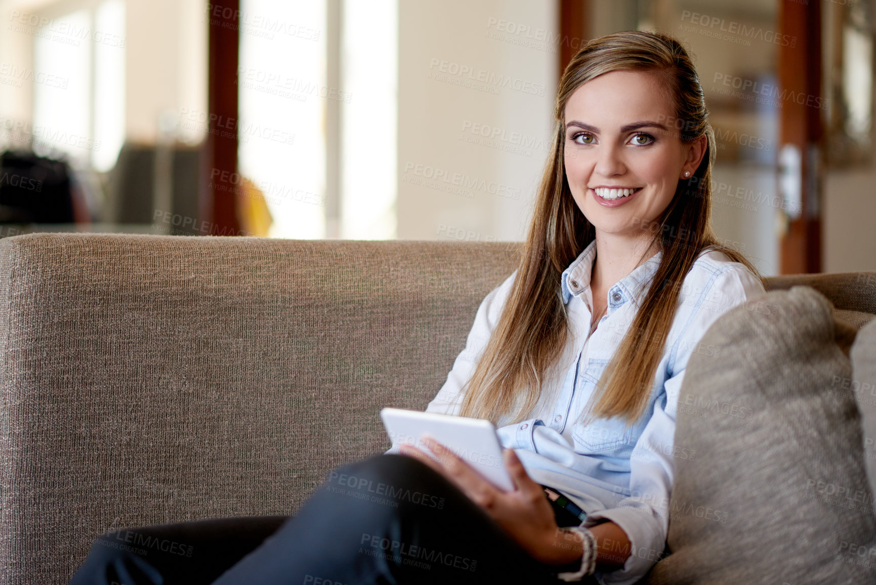 Buy stock photo Woman, tablet and relax on sofa, portrait or scroll for ebook, smile or film streaming at home. Person, happy and tech in lounge with application, subscription and social media at house in Spain
