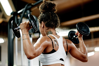 Buy stock photo Back, athlete and woman with dumbbells at gym for fitness, intense training and weightlifting. Female person, equipment and power workout with bodybuilder, strong muscle and challenge of bicep growth