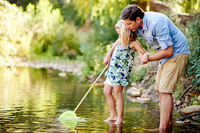 Buy stock photo Nature, bonding and child with father by lake for adventure, holiday and curiosity. Forest, entomology and girl with net, dad and conservation or vacation and rocks in woods with learning or explore