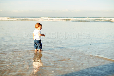 Buy stock photo Boy, toddler and sea at beach with waves, holiday and space outdoor for travel. Adventure, nature and summer fun with back of male child in ocean, games or playing with seaside vacation in Spain