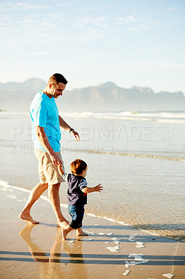 Buy stock photo Holding hands, walking and dad with child at beach for connection, summer vacation or holiday together. Family, space and man with toddler by waves for playing, fun and travel on weekend for bonding
