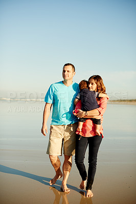 Buy stock photo Walking, parents and child at beach for holiday, summer trip and hug together. Father, mother and carrying toddler at seashore for family vacation, mockup space and travel for tourism with kid