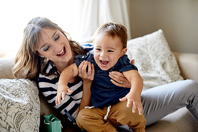 Buy stock photo Excited, laughing or playing with mother and son on sofa in living room of home together for fun. Birthday, celebration or funny with boy child and single parent woman in apartment for milestone
