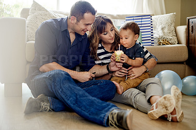 Buy stock photo Parents, kid and cupcake for birthday in home for milestone with blowing candle for celebration. Dessert, sweets and mother with boy toddler, father and cake at party or event in family house