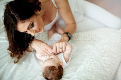 Buy stock photo Bed, cuddle or smile with baby and mother in home together for bonding, growth or love. Above, development or security with infant child and woman parent in bedroom of apartment for connection