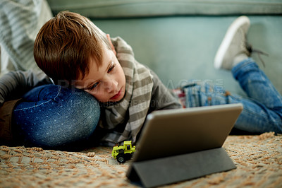 Buy stock photo Tablet, relax and child on floor in home for watching movie, video or film on streaming service. Digital technology, calm and boy kid enjoying show on app in living room for entertainment in house.