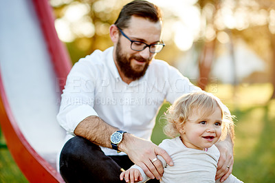 Buy stock photo Dad, girl and play on slide at park with baby, outdoor and summer with care, love and support. Father, toddler child and helping hand in nature, guide or safety for games with family in New Zealand