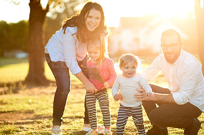 Buy stock photo Parents, children and smile in portrait at park with bonding, care and excited with flare in nature. Happy family, people and kids in garden, summer or outdoor with love for relationship in Spain
