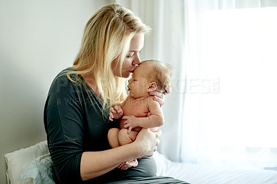 Buy stock photo Love, mother and kiss baby on bed for connection, bonding together and protection in nursery. People, new mom and comfort newborn in home for early childhood development, affection and relationship