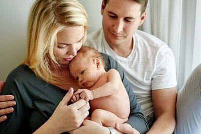 Buy stock photo Love, bonding and parents with baby in home for safety, relationship and connection for affection. Family, parenting and embrace with dad, mom and newborn for comforting, trust and security together