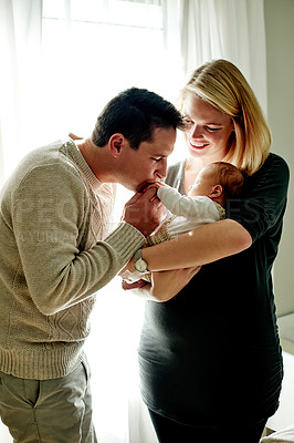 Buy stock photo Family, kiss and parents with baby in home for bonding, healthy relationship and love for affection. Happy, parenting and embrace with dad, mom and newborn for comforting, trust and security together