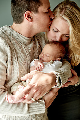 Buy stock photo Home, kiss and couple with baby, love and bonding together with infant, childcare and happiness. Support, family and mother with father, parents and newborn with wellness, relationship and kid