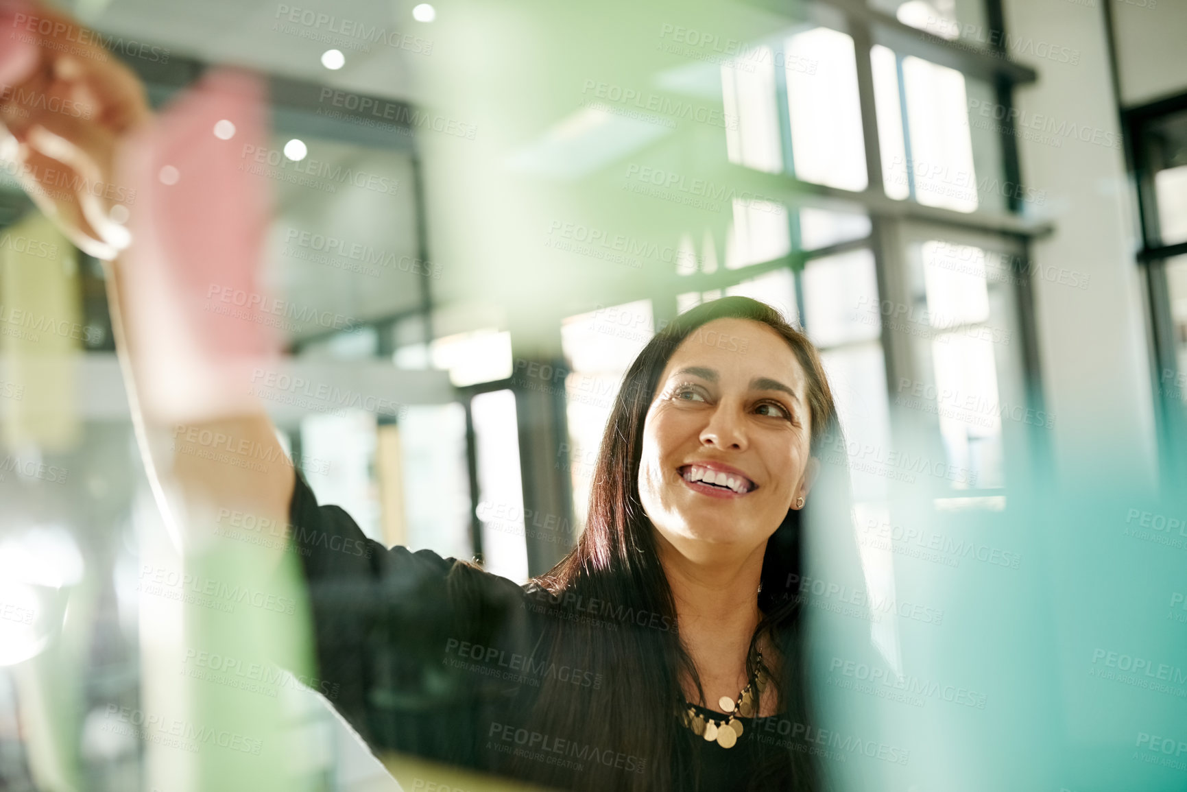 Buy stock photo Business woman, smile and thinking for sticky note, strategy or brainstorming in creative office. Glass wall, employee and research with ideas, planning or schedule tasks for event project management