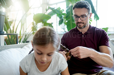 Buy stock photo Man, girl and hair braid in home with bonding, helping and support for morning routine. Smile, daughter and single parent on couch with grooming, together and getting ready in living room for school.