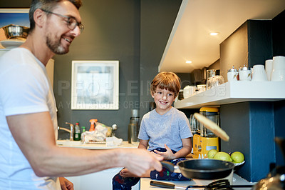 Buy stock photo Happy, cooking and father with child in kitchen with conversation, bonding and morning routine. Smile, connection and dad with boy kid for talking and preparing breakfast together on weekend in house