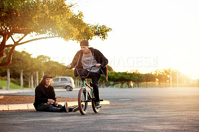 Buy stock photo City, sunset and man on bicycle for cycling, training skill or tricks in urban town to practice. Cool friends, athlete or stunt biker in parking lot for exercise, fitness or outdoor sports for biking