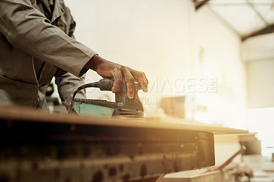 Buy stock photo Carpenter, hand or man in workshop with orbital sander, flare or repair for home renovation. Person, worker or craft on surface with power tool, maintenance or project in construction warehouse.