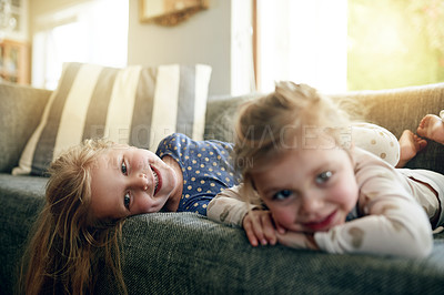 Buy stock photo Portrait, siblings and children on break, lounge and girls with smile on sofa, bonding and together. Happy, sisters and relax on couch, home and kids in living room, chill or family in apartment