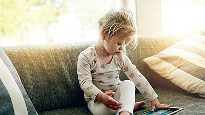 Buy stock photo Playing, video game and child with tablet, home and relax with tech and development of motor skills. Online, toddler and girl with app for entertainment, growth and cognitive functions in living room