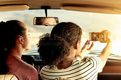 Buy stock photo Women, friends and back with selfie in car for road trip memory, photography or picture. Female people, travel and vehicle with capture moment for social media post, bonding or holiday together