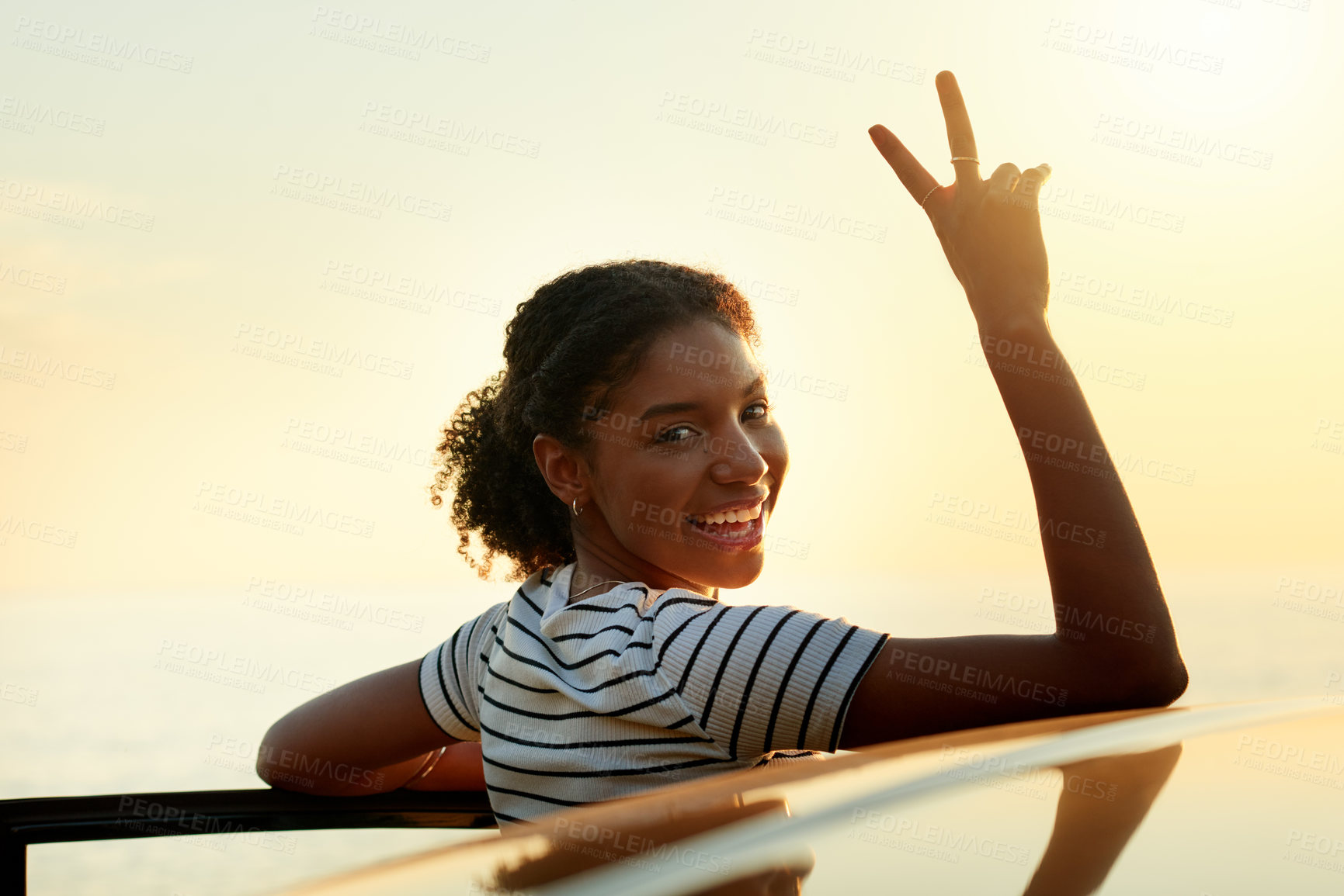 Buy stock photo Happy woman, portrait and peace sign with vehicle for sunset view, travel or outdoor holiday. Female person, driver or smile with hand gesture for stop, road trip adventure or weekend getaway in car