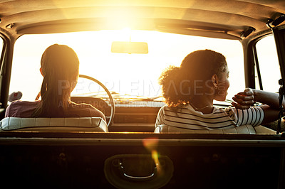 Buy stock photo Shot of two young women enjoying a road trip