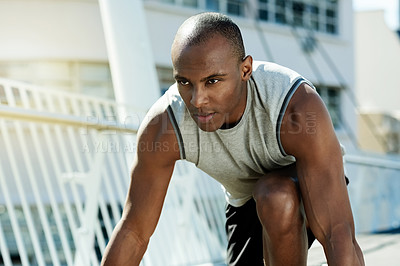 Buy stock photo Black man, runner and start race in city for exercise, cardio training and competition. Male person, ready and preparation for running challenge, sports workout and marathon practice for wellness