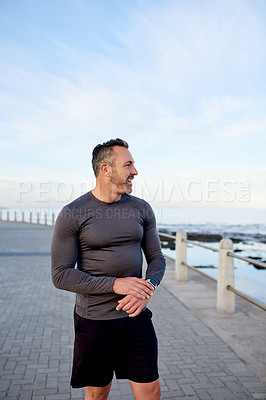 Buy stock photo Happy, running and man by ocean promenade for exercise, marathon training and cardio workout. Sports, sunshine and person for wellness, health and recovery for performance, endurance and fitness