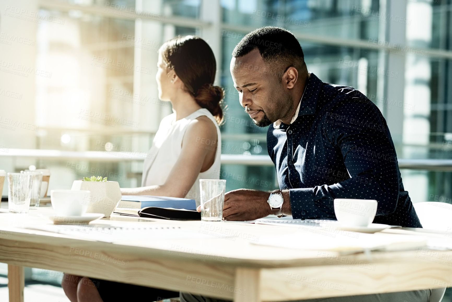 Buy stock photo Boardroom, employees and man with document, serious and prepare for meeting with report or campaign. Review, results or people with paperwork for ad performance, marketing manager or plan in business