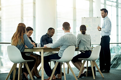 Buy stock photo Businessman, meeting and coaching team with whiteboard in office for staff training or project. Male person, speaker or presentation with group of employees for company strategy or ideas in workplace