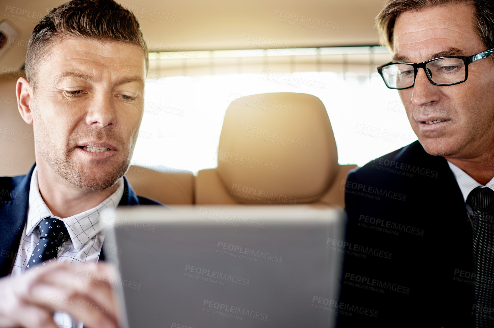 Buy stock photo Car, conversation and tablet with business men in backseat of vehicle for discussion or planning. App, collaboration and travel with employee people on drive for transportation to work location