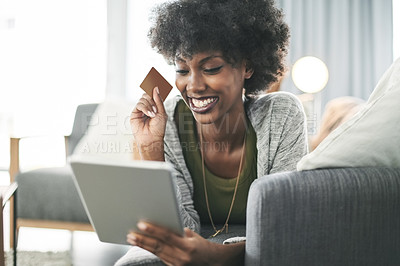 Buy stock photo Credit card, smile and black woman on tablet on sofa for online shopping, payment and digital order. Happy, home and person on tech with bank info for website sale, discount and ecommerce purchase