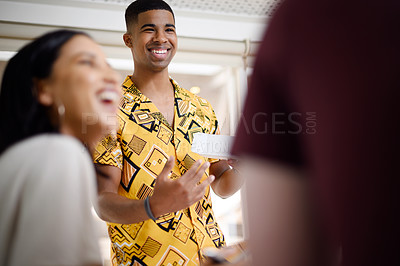 Buy stock photo Shot of a young businessman having a discussion with his colleagues in an office