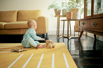 Buy stock photo Baby, toy car and play in home, having fun and learning, relaxing or growth. Development, childhood and kid, newborn or toddler playing with wooden truck or toys and enjoying time alone in house.