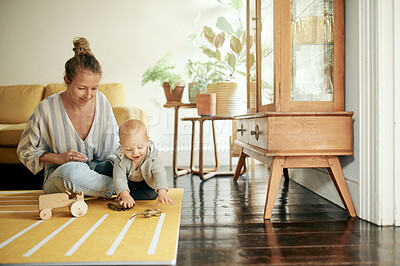 Buy stock photo Baby, toy and mom playing with newborn on the floor of a house or home and bonding together. Care, motherhood and single parent or woman having fun with infant or kid for child development