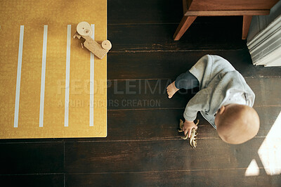 Buy stock photo Baby, living room and floor with a kids toy ready for learning to walk in a home. Above, young child and mobility development of a toddler in a house lounge playing with children and youth toys