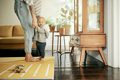Buy stock photo Happy family, walking and mother and baby in home for bonding, quality time and relax together. Living room, love and mom holding hands with kid for child development, care and happiness on weekend