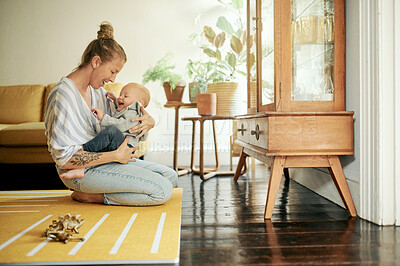 Buy stock photo Mother smile, baby and play in home living room, bonding and having fun together. Development, happiness and mama holding child, kid or newborn, playing and care while enjoying quality time in house.