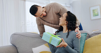 Buy stock photo Couple, smile and gift in home with love for Christmas celebration, support or partner appreciation. Excited, present and happy people on sofa for care, connection and thank you on xmas holiday