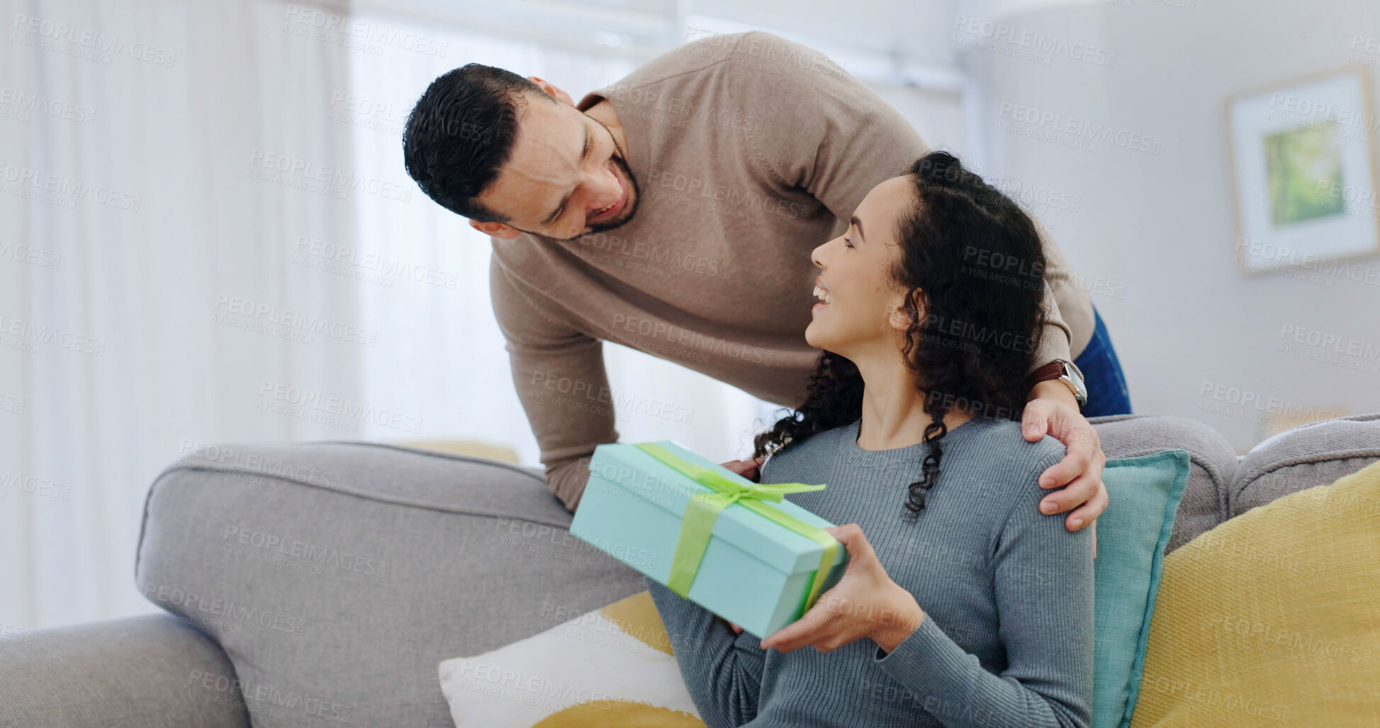 Buy stock photo Couple, smile and gift in home with love for Christmas celebration, support or partner appreciation. Excited, present and happy people on sofa for care, connection and thank you on xmas holiday