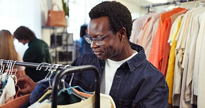 Buy stock photo Shopping, check or man in store with clothing rack, outfit search or decision in trendy style. Retail, smile or customer in boutique with apparel, garment choice or selection in fashion purchase.