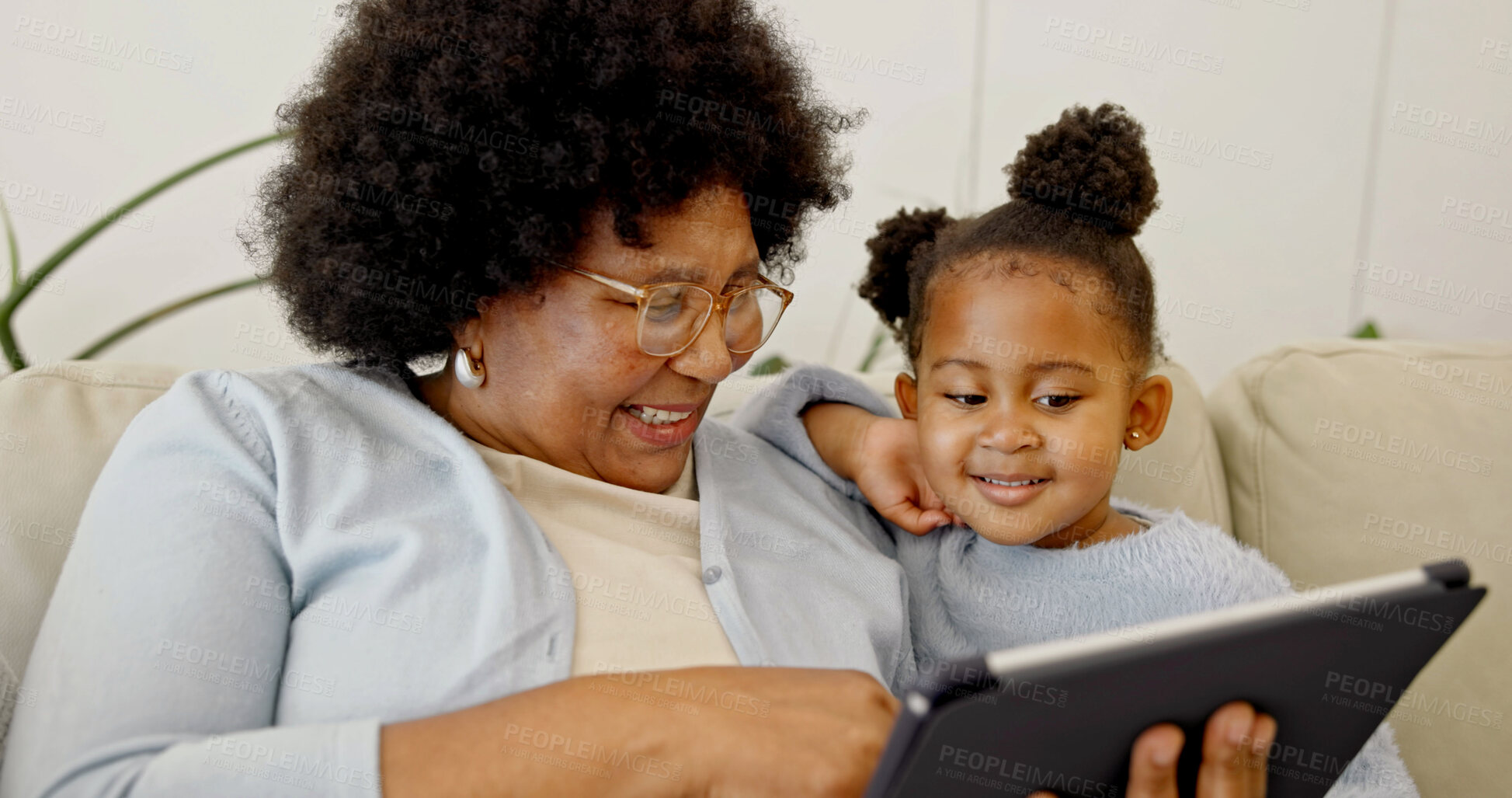 Buy stock photo Grandma, bonding and child with tablet in home, laughing and watching cartoons with subscription. Family, online and senior black woman with daughter, happy and streaming movie with tech in house