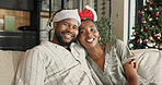 Christmas, portrait or black couple with hug in home for festive celebration, comfort or holiday. Happy, man and woman relaxing on sofa for December vacation, weekend or bonding together in house