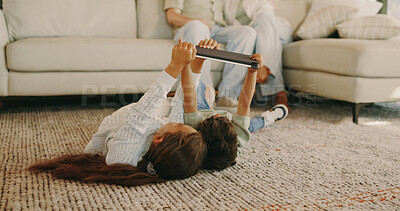 Buy stock photo Children, online and bonding with tablet, home and watch cartoons with app subscription in lounge. Siblings, relax and streaming movie with technology, family and kids with parents in living room