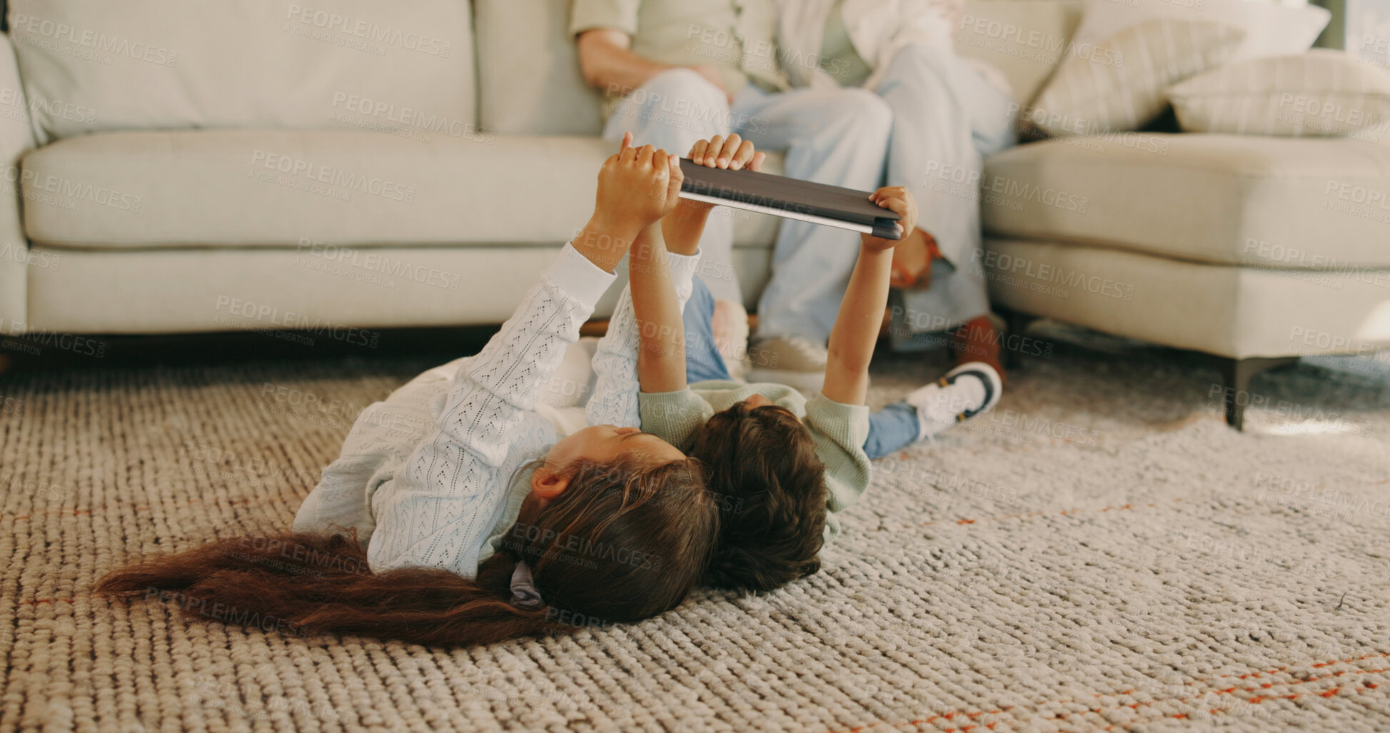 Buy stock photo Children, online and bonding with tablet, home and watch cartoons with app subscription in lounge. Siblings, relax and streaming movie with technology, family and kids with parents in living room