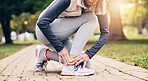 Senior, woman and hands with shoe tying in park for outdoor workout preparation or exercise. Active, elderly or female person getting ready with sneakers or laces for fitness or training in nature