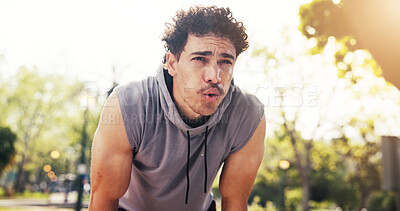 Buy stock photo Fitness, breathing and tired man on break at park for wellness, health or workout pause for recovery. Exhausted runner, male person and resting outdoor with fatigue, exercise lifestyle or challenge