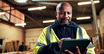 Scroll, black man and tablet in workshop for carpentry project specs, fixture design or cut list. Craft, mature shopfitter or tech for CAD review, joinery software or client email for furniture order