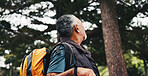 Hiking, view and senior man in nature for trekking, fitness and exercise for wellness on weekend. Sightseeing, mountain and person in woods for bird watching, backpacking or travel outdoor for health