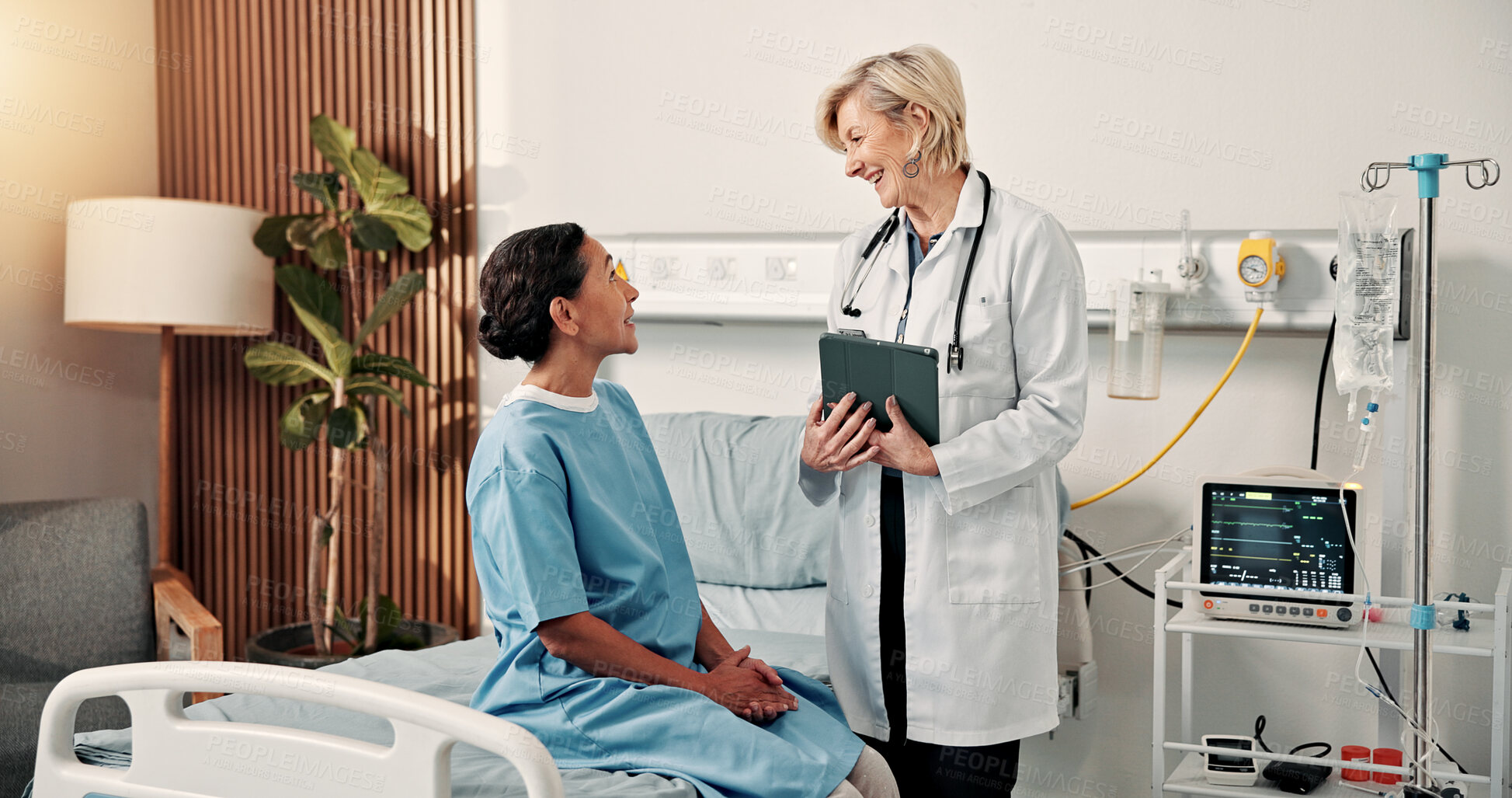 Buy stock photo Happy, doctor and woman on hospital bed with good news, discussion and complete cancer remission. Medical worker, mature person and talk in clinic with smile, disease recovery or ready for discharge.